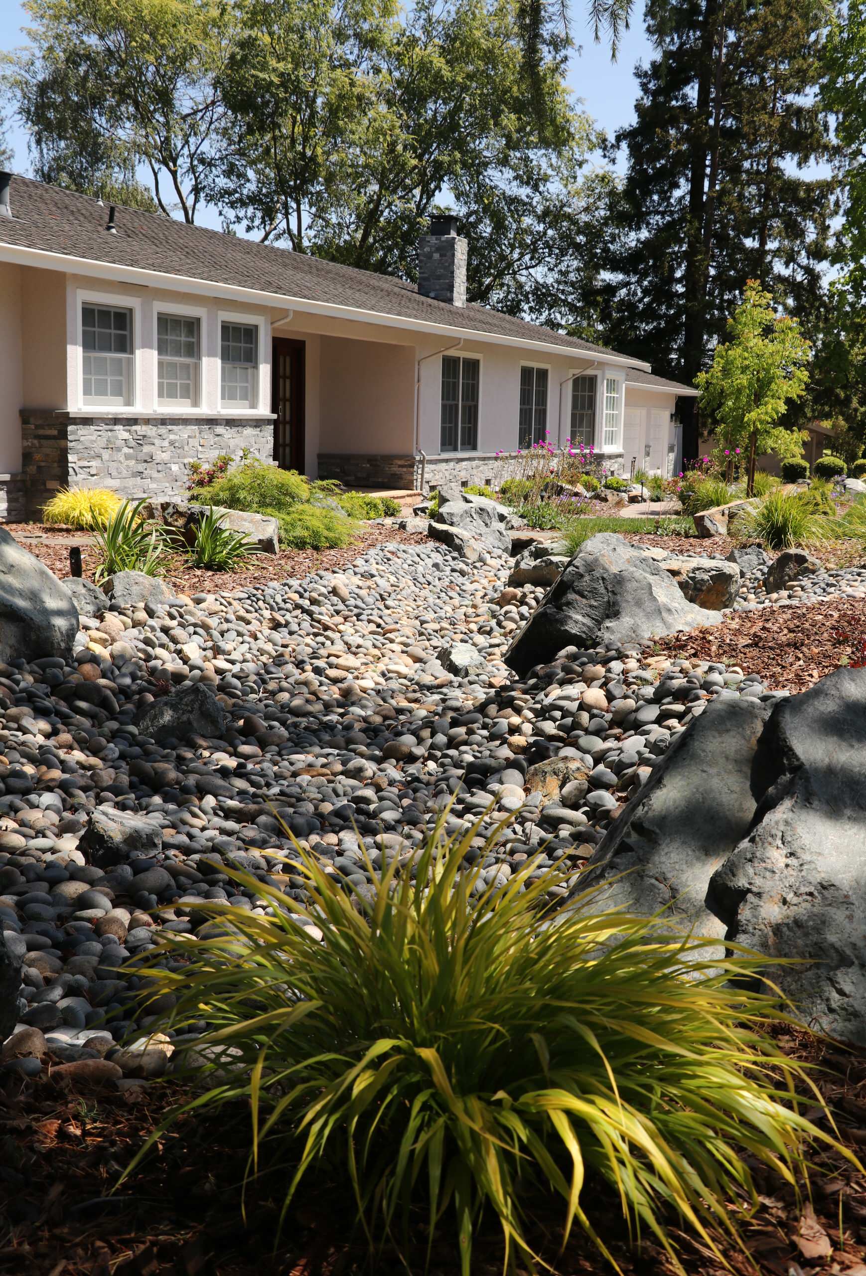 FRONT YARD WITH TREES AND DRY-CREEK