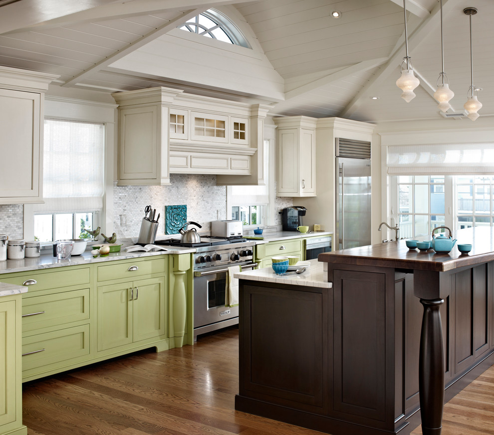 Design ideas for a beach style l-shaped eat-in kitchen in Philadelphia with a farmhouse sink, shaker cabinets, quartzite benchtops, white splashback, stone tile splashback, stainless steel appliances and green cabinets.