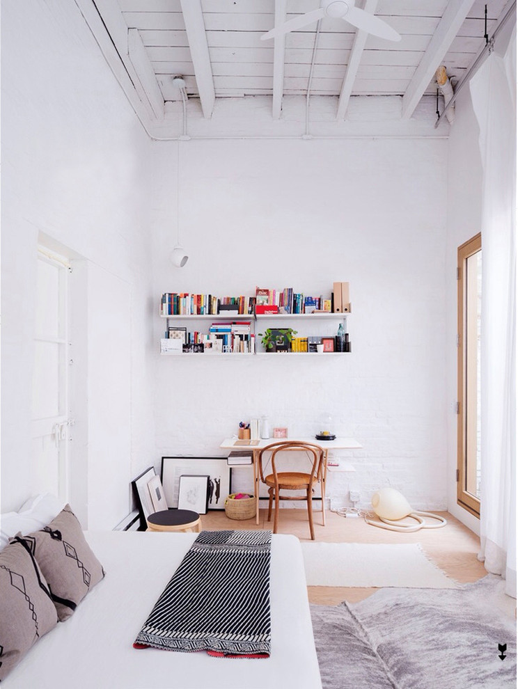 Design ideas for an industrial bedroom in New York with white walls.