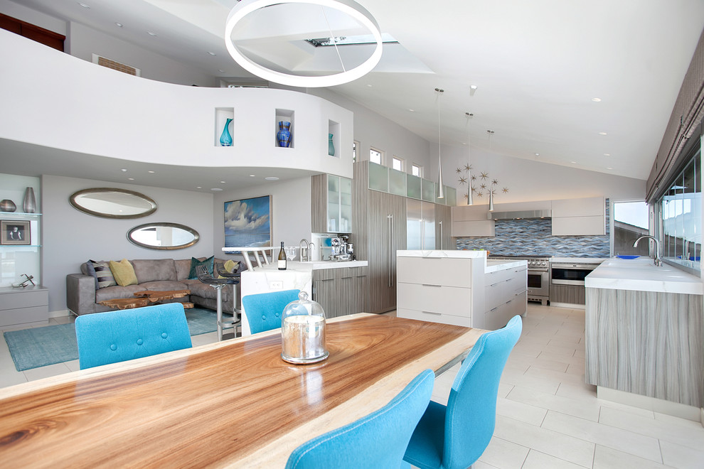 This is an example of a large contemporary u-shaped open plan kitchen in San Diego with an undermount sink, flat-panel cabinets, grey cabinets, tile benchtops, blue splashback, glass tile splashback, stainless steel appliances, porcelain floors and with island.