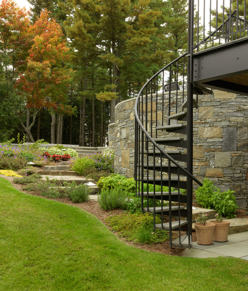 Inspiration for a transitional sloped garden in Burlington with natural stone pavers.