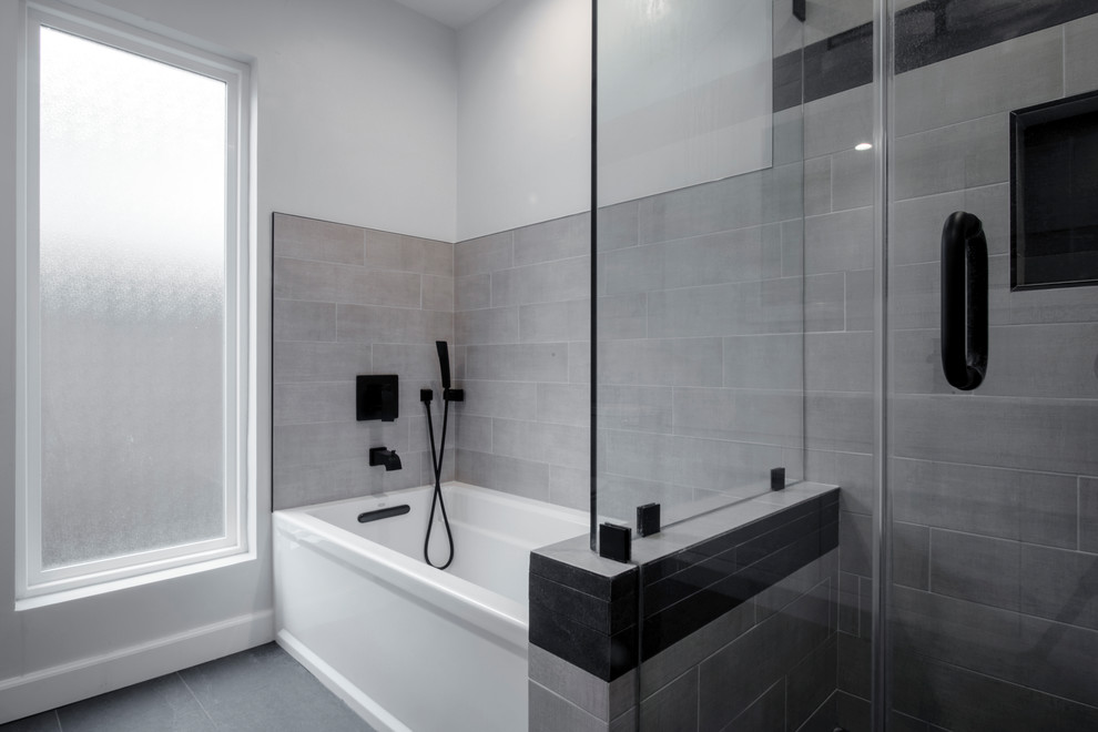 Inspiration for a mid-sized modern kids bathroom in Los Angeles with flat-panel cabinets, white cabinets, an alcove tub, an open shower, a one-piece toilet, gray tile, porcelain tile, white walls, slate floors, an integrated sink, solid surface benchtops, black floor, a hinged shower door and white benchtops.