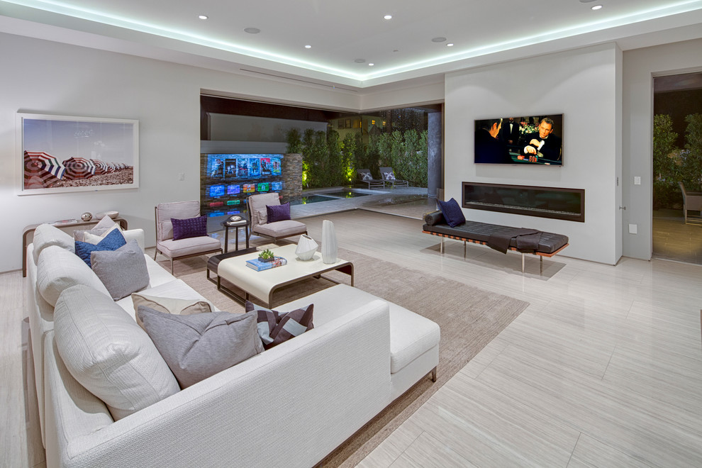 Large contemporary open concept family room in Los Angeles with a ribbon fireplace, white walls, a plaster fireplace surround, porcelain floors and a wall-mounted tv.