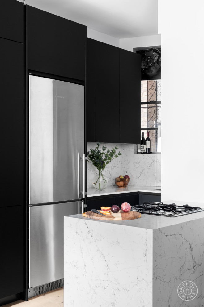 Eat-in kitchen - small contemporary u-shaped light wood floor eat-in kitchen idea in New York with a drop-in sink, flat-panel cabinets, black cabinets, quartz countertops, white backsplash, quartz backsplash, stainless steel appliances, a peninsula and white countertops