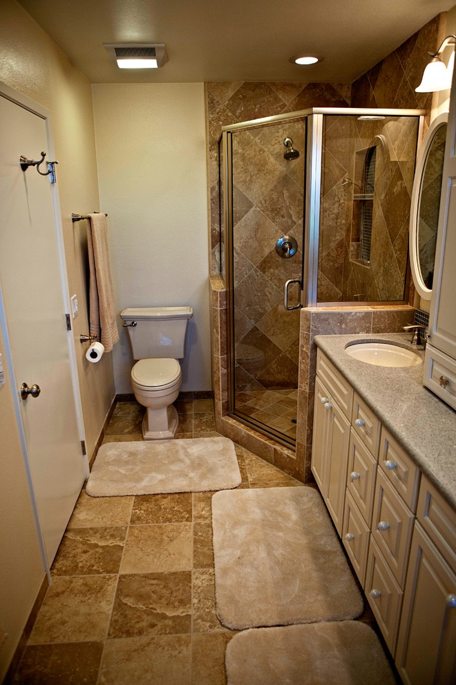 This is an example of a mid-sized traditional master bathroom in Orange County with an undermount sink, raised-panel cabinets, white cabinets, engineered quartz benchtops, a drop-in tub, a corner shower, a two-piece toilet, beige tile, porcelain tile, beige walls and porcelain floors.