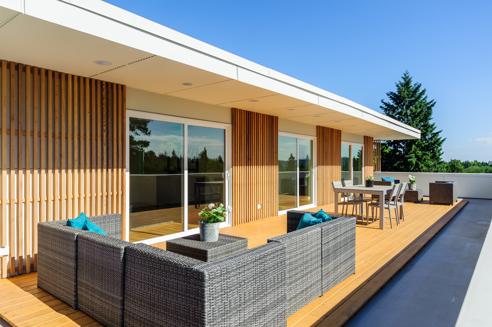 Photo of a large modern rooftop deck in Seattle with an awning.
