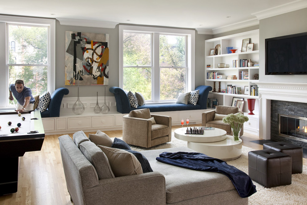 This is an example of a contemporary living room in Boston with a stone fireplace surround.