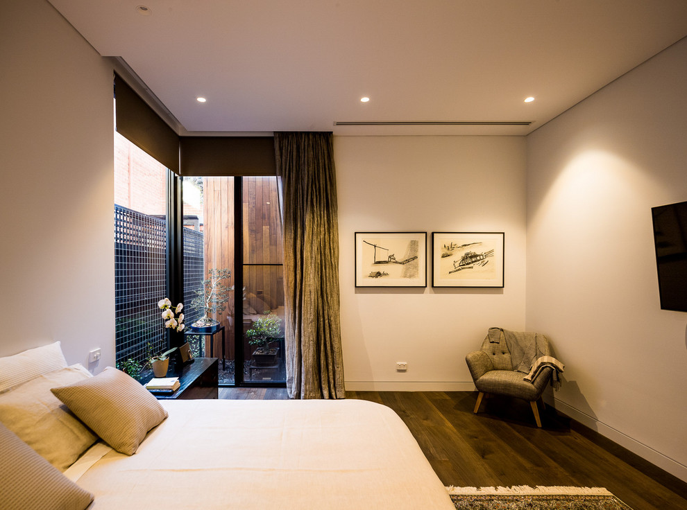 Inspiration for a large contemporary master bedroom in Melbourne with white walls and dark hardwood floors.