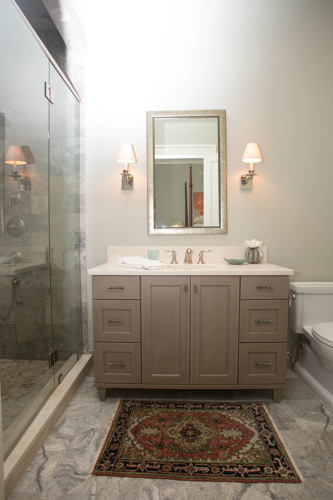 Design ideas for a mid-sized traditional bathroom in New Orleans with an undermount sink, recessed-panel cabinets, grey cabinets, stone tile and marble floors.