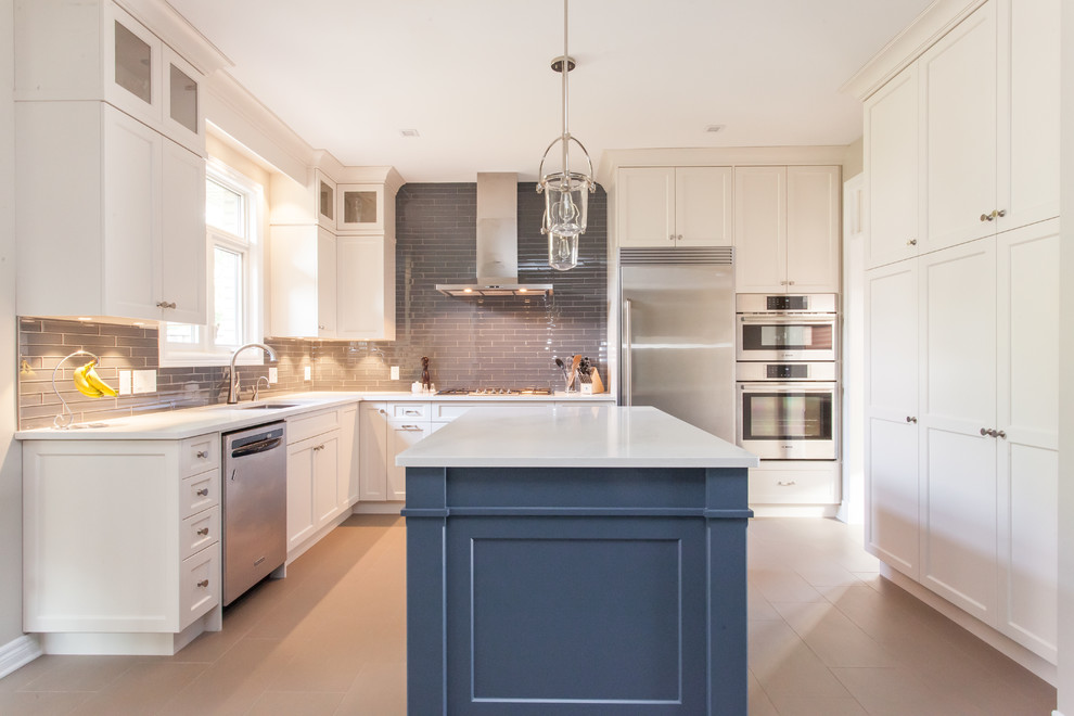 Large transitional u-shaped porcelain tile and gray floor eat-in kitchen photo in Toronto with an undermount sink, recessed-panel cabinets, white cabinets, quartz countertops, gray backsplash, subway tile backsplash, stainless steel appliances, an island and white countertops