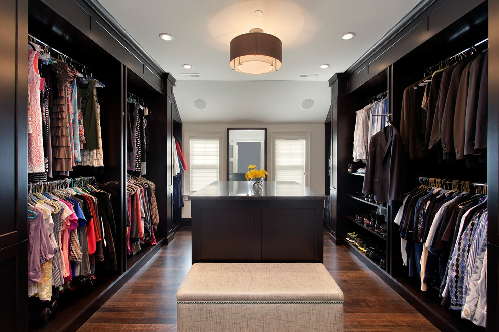 Inspiration for a transitional dressing room in Chicago with dark hardwood floors and black cabinets.