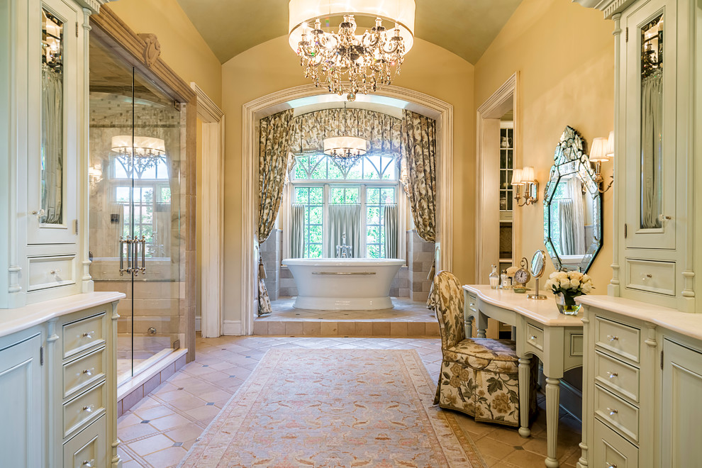 Photo of an expansive traditional master bathroom in Chicago with recessed-panel cabinets, light wood cabinets, a freestanding tub, beige tile, porcelain tile, yellow walls, terra-cotta floors, granite benchtops, an alcove shower and a hinged shower door.