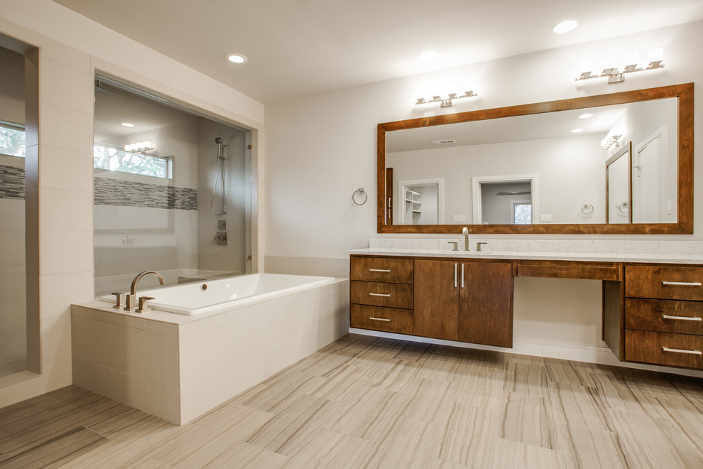 This is an example of a mid-sized modern master bathroom in Dallas with flat-panel cabinets, medium wood cabinets, marble benchtops, a drop-in tub, an alcove shower, a two-piece toilet, white tile, stone slab, white walls, slate floors, an undermount sink, beige floor and an open shower.