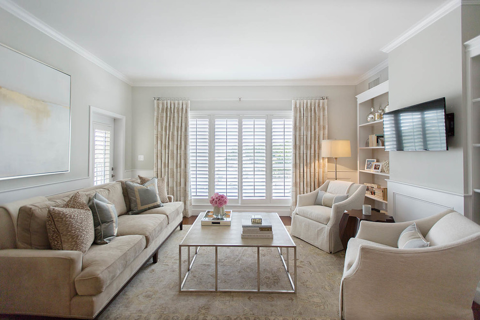 Inspiration for a mid-sized transitional enclosed dark wood floor living room library remodel in Orlando with a wall-mounted tv, no fireplace and gray walls