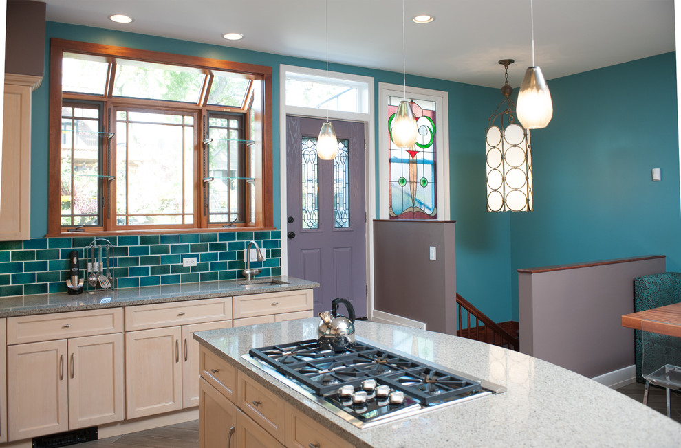 Photo of a transitional u-shaped eat-in kitchen in Chicago with an undermount sink, shaker cabinets, light wood cabinets, matchstick tile splashback and stainless steel appliances.