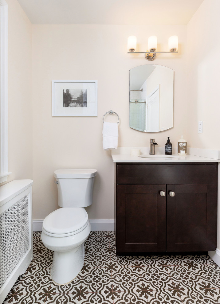 Small contemporary 3/4 bathroom in Philadelphia with shaker cabinets, dark wood cabinets, a two-piece toilet, pink walls, cement tiles, an undermount sink, engineered quartz benchtops, multi-coloured floor and white benchtops.