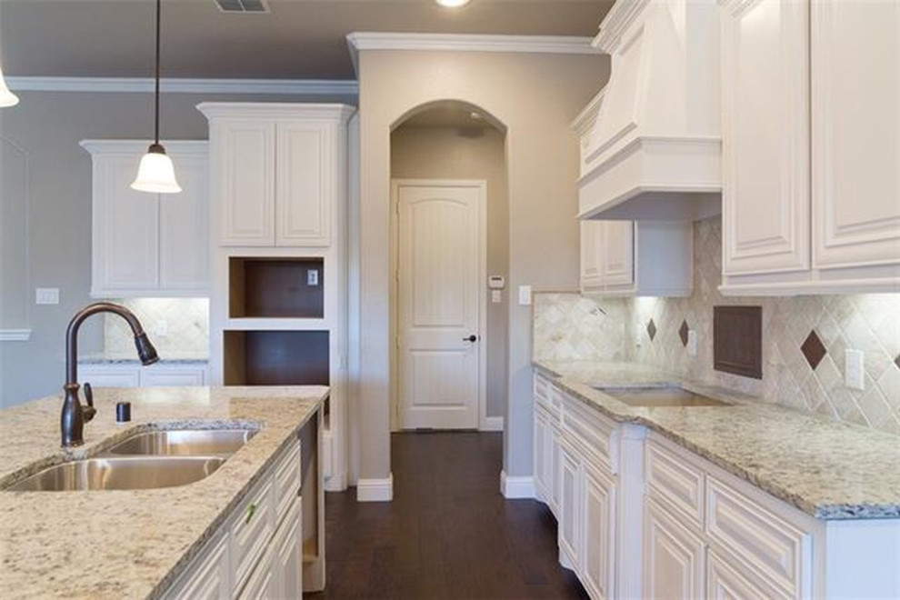 Open concept kitchen - large transitional l-shaped dark wood floor open concept kitchen idea with raised-panel cabinets, white cabinets, beige backsplash, colored appliances, an island and a double-bowl sink