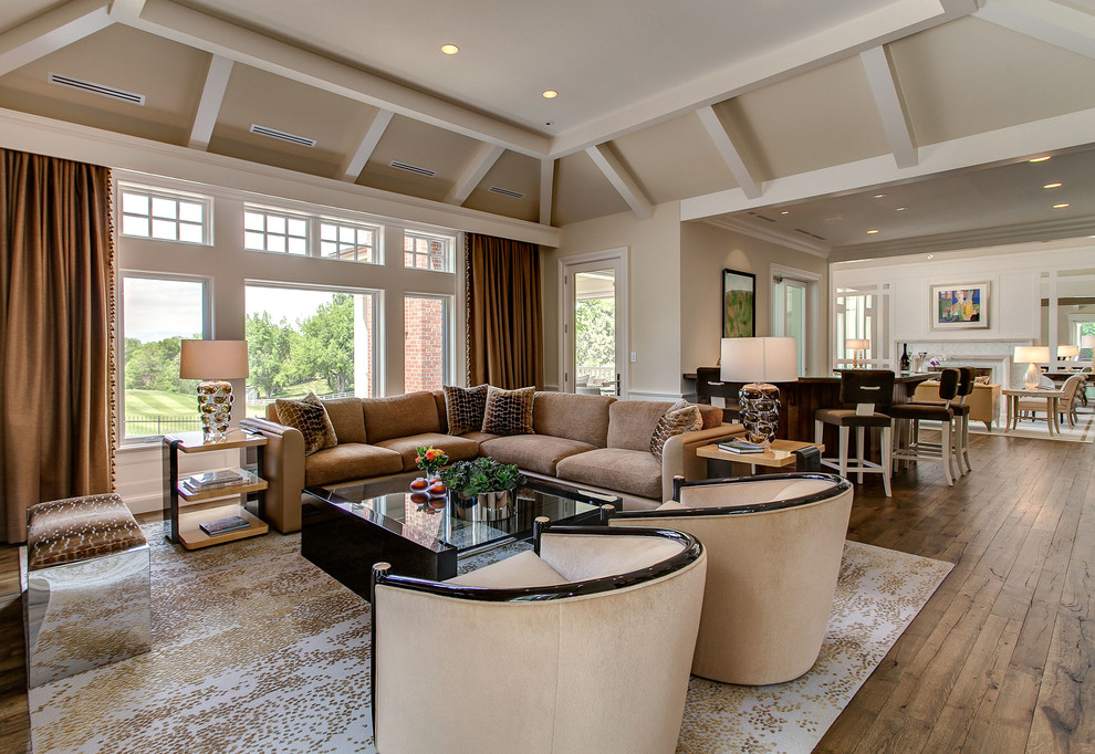 This is an example of a transitional open concept family room in Denver with medium hardwood floors.