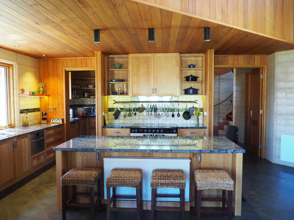 Inspiration for a large country open plan kitchen in Melbourne with a double-bowl sink, recessed-panel cabinets, medium wood cabinets, granite benchtops, multi-coloured splashback, ceramic splashback, ceramic floors and with island.