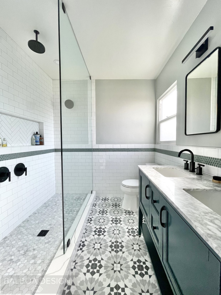 This is an example of a small country 3/4 bathroom in San Diego with shaker cabinets, green cabinets, an alcove shower, a two-piece toilet, white tile, subway tile, green walls, porcelain floors, an undermount sink, marble benchtops, multi-coloured floor, an open shower, white benchtops, a niche, a double vanity and a freestanding vanity.