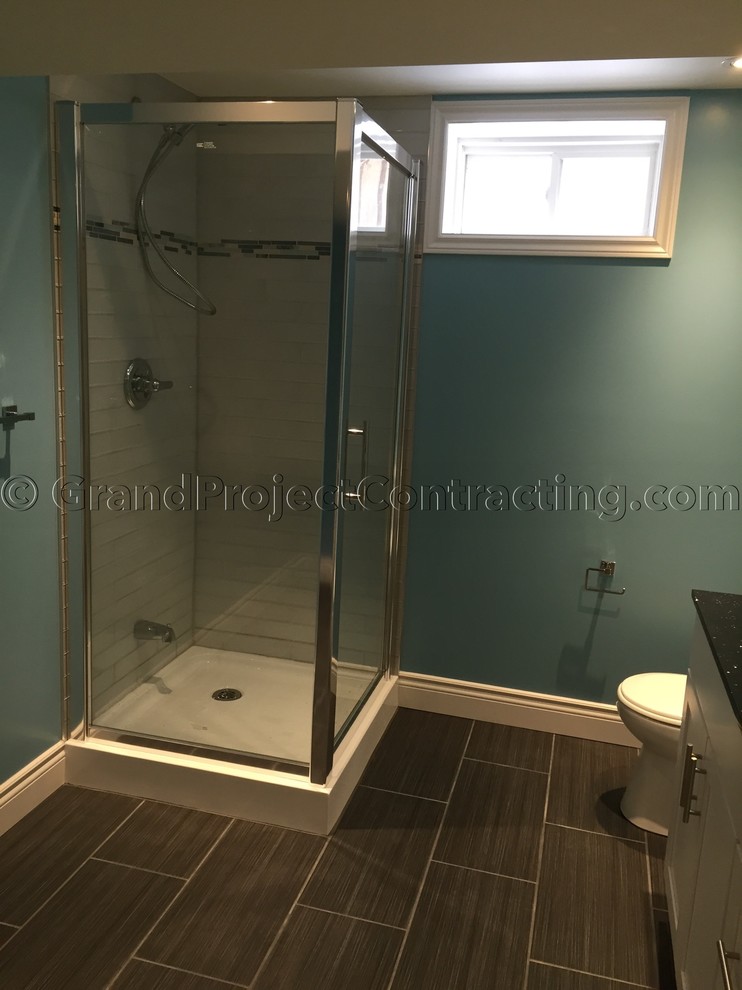 Mid-sized traditional 3/4 bathroom in Toronto with a drop-in sink, furniture-like cabinets, white cabinets, granite benchtops, a corner shower, a one-piece toilet, white tile, glass tile, blue walls and ceramic floors.