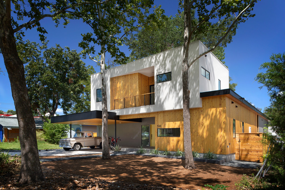This is an example of a mid-sized modern two-storey exterior in Austin with a flat roof.