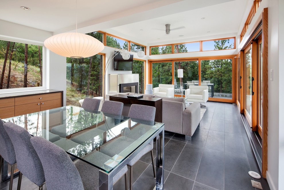 Photo of a large contemporary open plan dining in Vancouver with white walls and concrete floors.