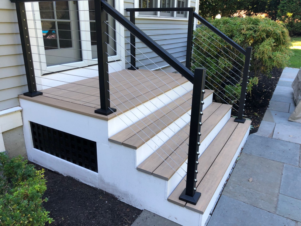Photo of an arts and crafts backyard deck in Boston with metal railing.