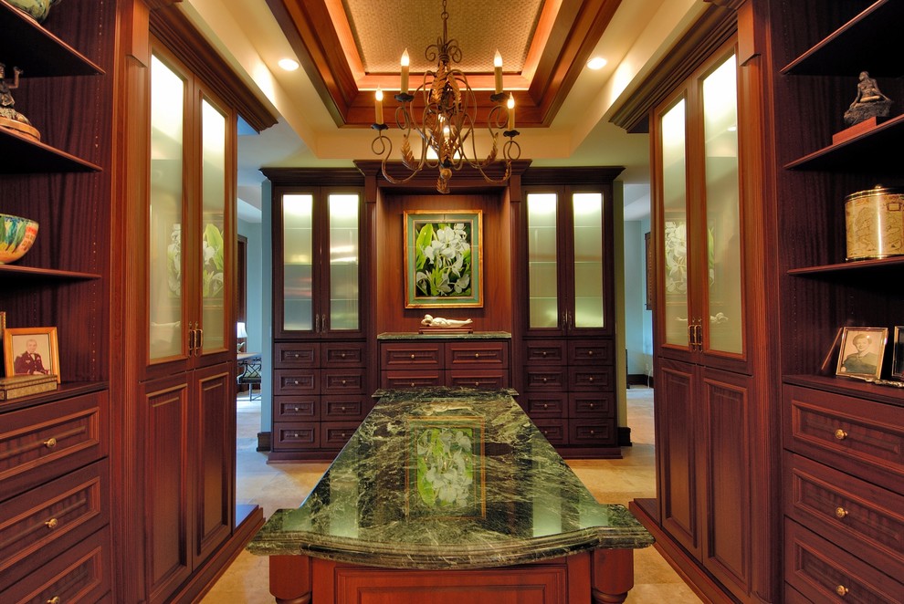 Tropical dressing room in Hawaii with dark wood cabinets and raised-panel cabinets.