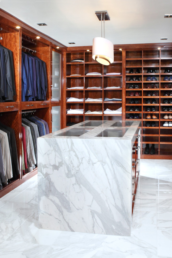 This is an example of a large contemporary gender-neutral walk-in wardrobe in Philadelphia with flat-panel cabinets, medium wood cabinets and marble floors.