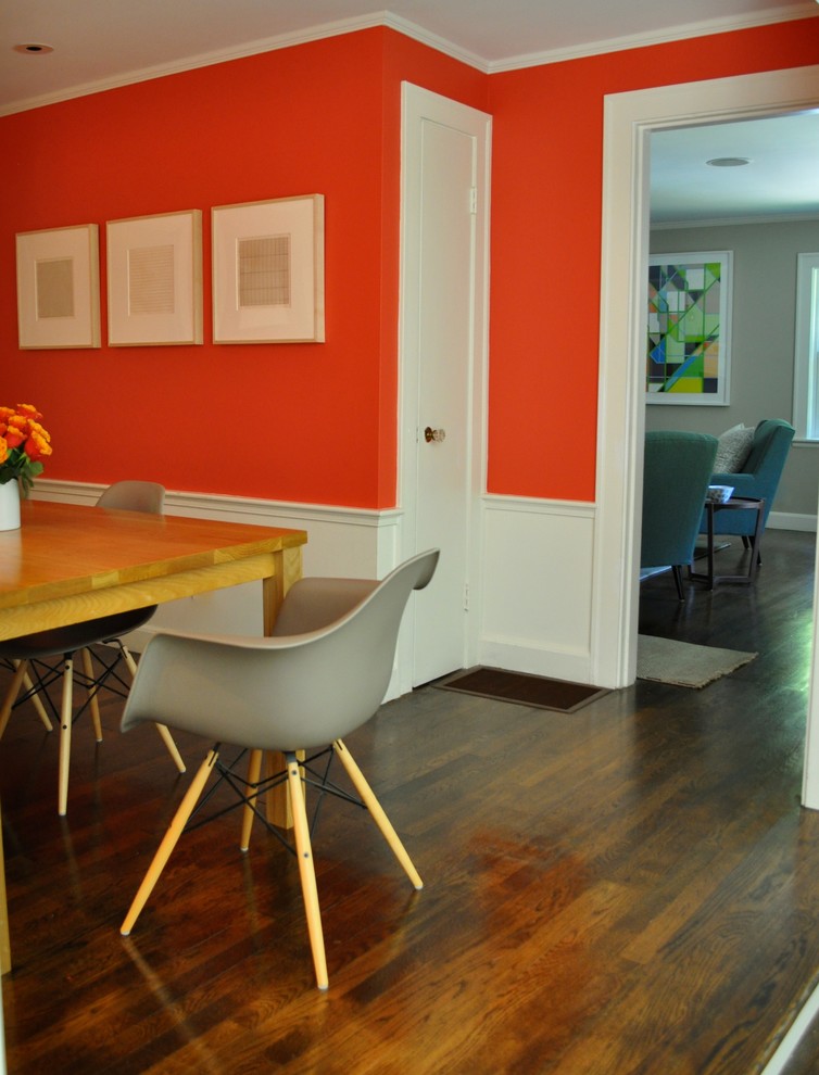 This is an example of a mid-sized midcentury separate dining room in Boston with red walls and dark hardwood floors.