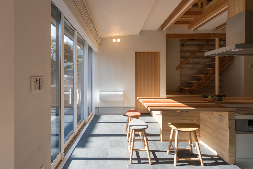 Asian open plan dining in Tokyo with white walls and grey floor.