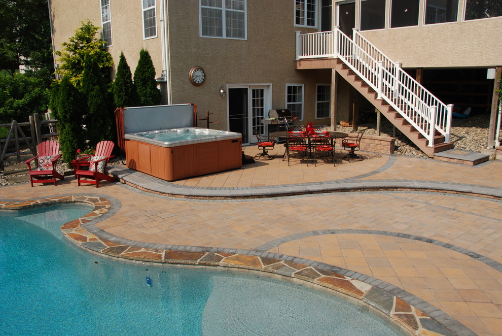 Mid-sized traditional backyard patio in Philadelphia with a water feature, concrete pavers and no cover.