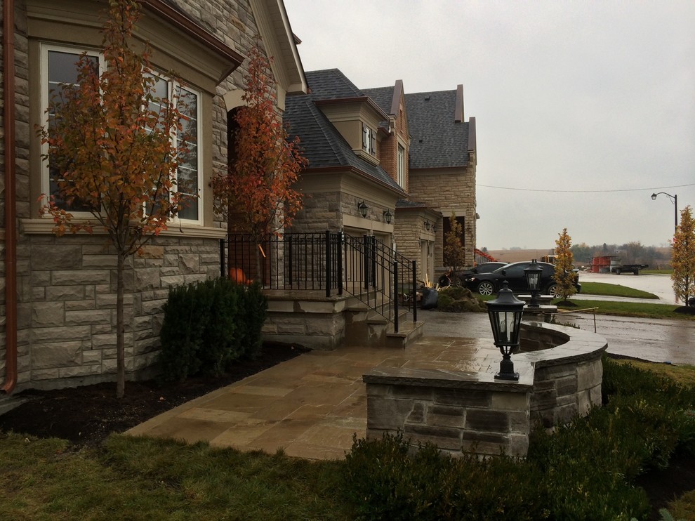 Design ideas for a mid-sized rustic partial sun front yard concrete paver driveway in Toronto for summer.