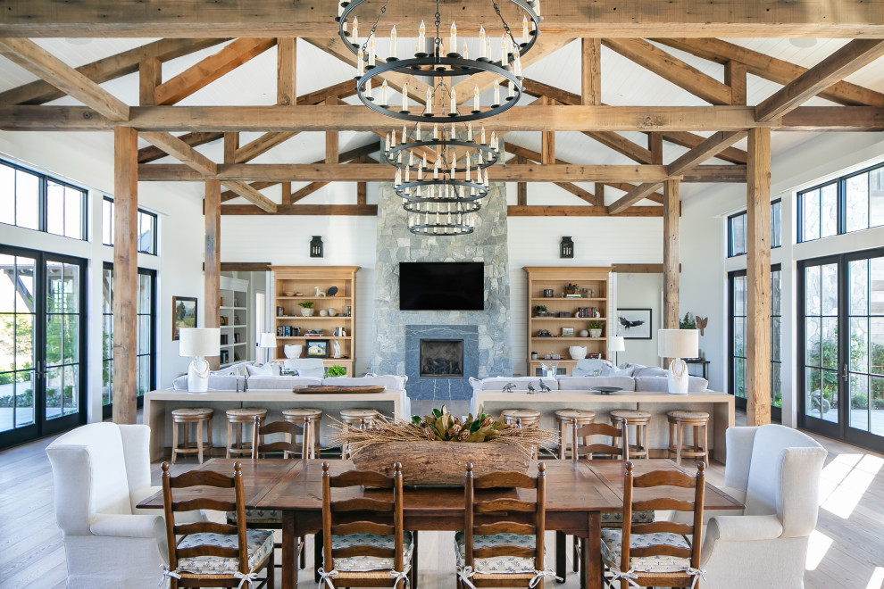 Inspiration for a country open plan dining in Orange County with white walls, medium hardwood floors, brown floor, timber, vaulted and planked wall panelling.