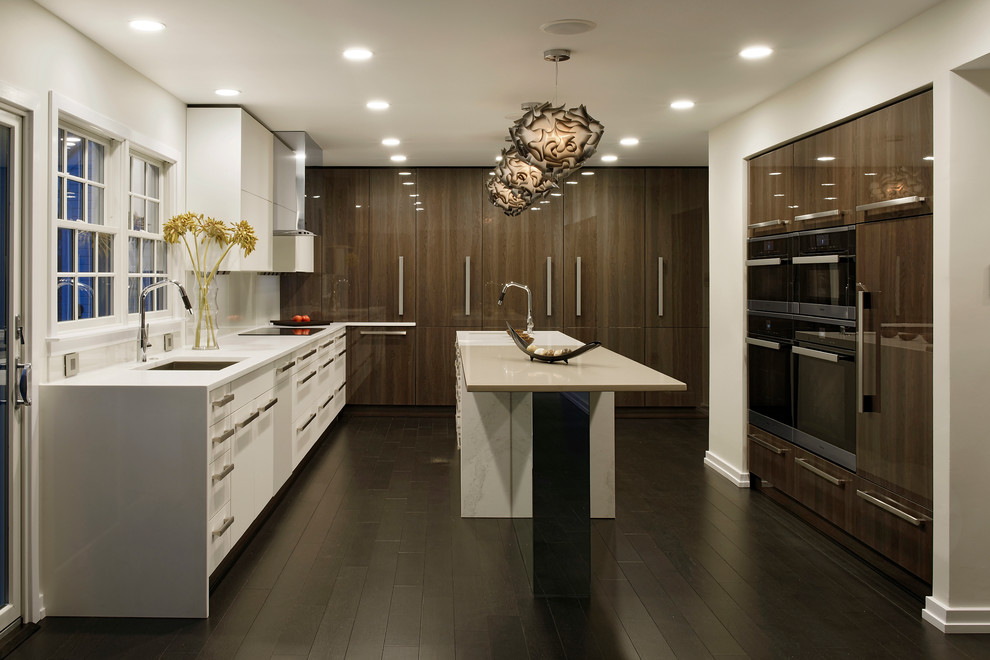 Design ideas for a large contemporary u-shaped kitchen in Baltimore with an undermount sink, flat-panel cabinets, dark hardwood floors, with island, white cabinets, quartzite benchtops, grey splashback, mirror splashback and panelled appliances.