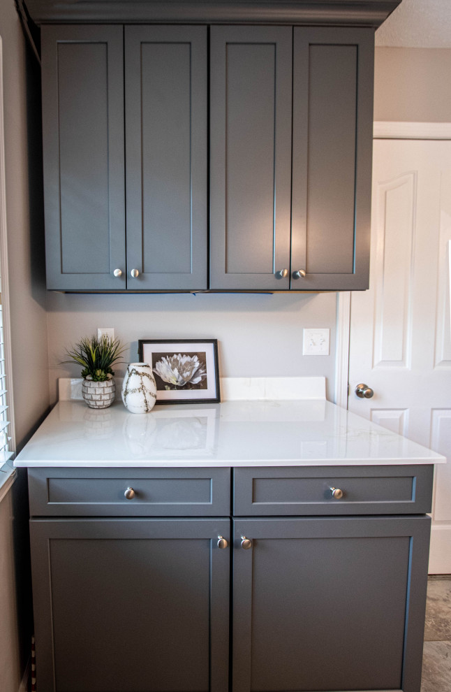Photo of a small classic galley utility room in Cleveland with flat-panel cabinets and grey cabinets.