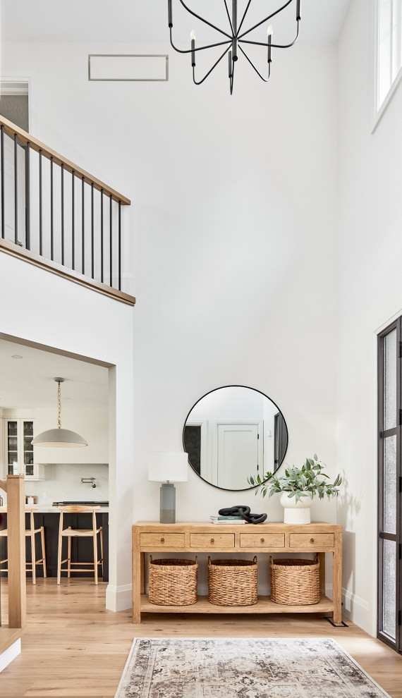 Foyer - mid-sized transitional vaulted ceiling, medium tone wood floor and brown floor foyer idea with white walls and a dark wood front door