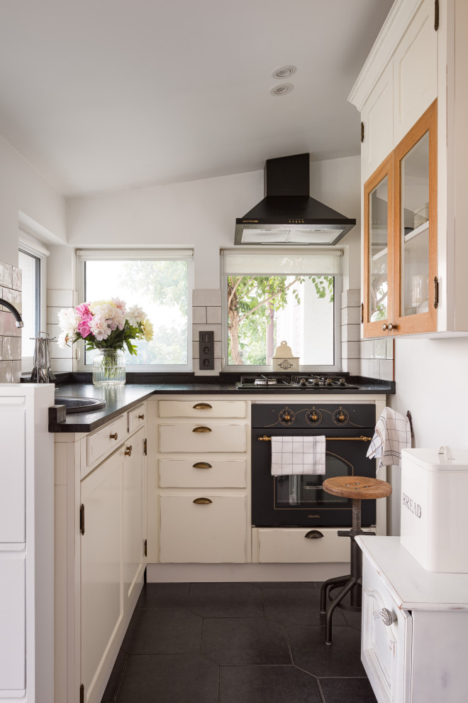 Inspiration for a small scandi l-shaped enclosed kitchen in Other with a single-bowl sink, raised-panel cabinets, beige cabinets, granite worktops, beige splashback, metro tiled splashback, black appliances, ceramic flooring, no island, black floors, black worktops and a coffered ceiling.