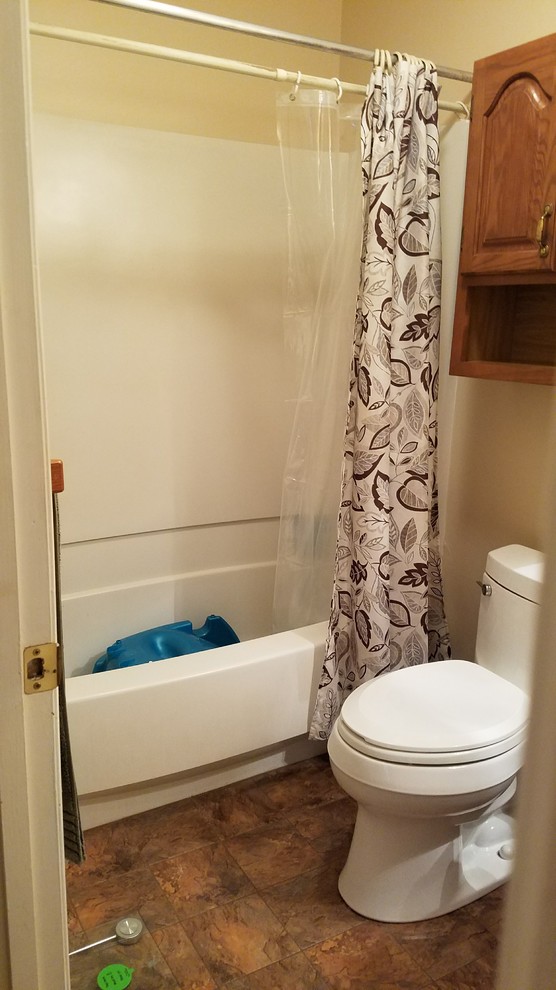 Home design - small rustic kids' gray tile and porcelain tile porcelain tile and gray floor home design idea with furniture-like cabinets, distressed cabinets, a two-piece toilet, gray walls, an undermount sink, granite countertops and a hinged shower door