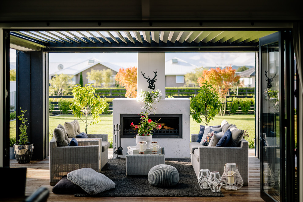 Design ideas for a country backyard deck in Hamilton with a fire feature and a pergola.