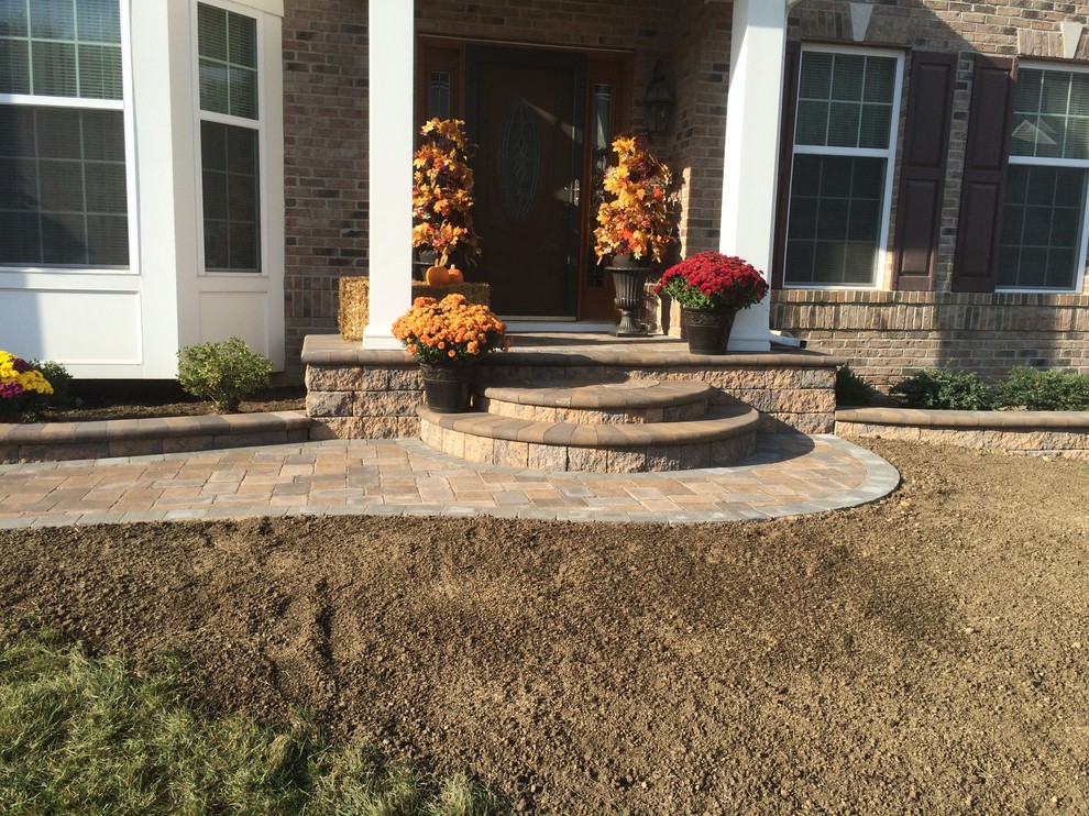 This is an example of a mid-sized country front yard garden in Wilmington with a garden path and brick pavers.