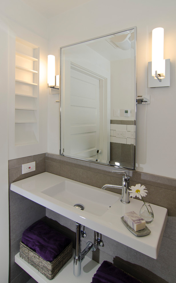 This is an example of a small modern 3/4 bathroom in Cincinnati with open cabinets, white cabinets, an open shower, ceramic tile, white walls, ceramic floors, a wall-mount sink, grey floor, an open shower, gray tile and engineered quartz benchtops.