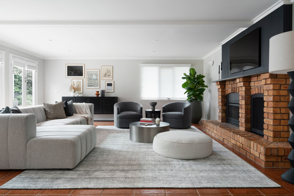 Design ideas for a large contemporary loft-style living room in Melbourne with white walls, porcelain floors, a standard fireplace, a brick fireplace surround and orange floor.