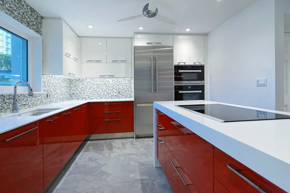 This is an example of a large modern l-shaped open plan kitchen in Tampa with an undermount sink, flat-panel cabinets, white cabinets, quartzite benchtops, grey splashback, stainless steel appliances and with island.