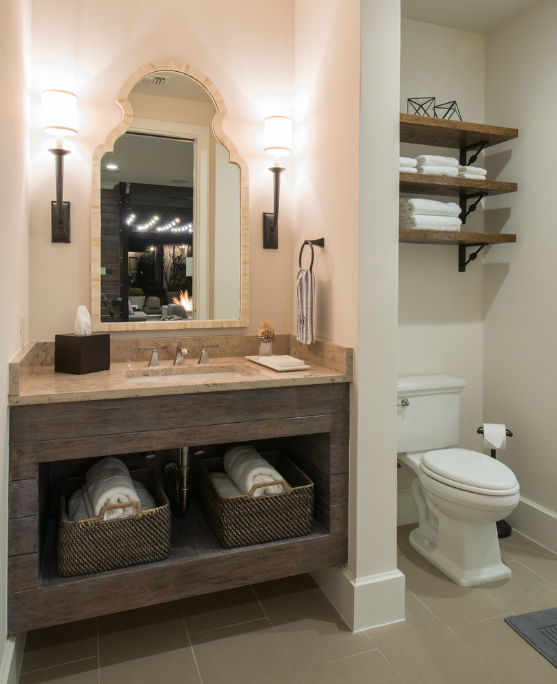 Photo of a large transitional 3/4 bathroom in Dallas with an undermount sink, open cabinets, distressed cabinets, limestone benchtops, a curbless shower, a two-piece toilet, gray tile, porcelain tile, white walls and porcelain floors.
