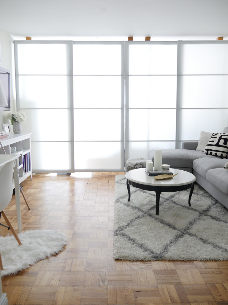 Inspiration for a small traditional enclosed living room in New York with white walls.