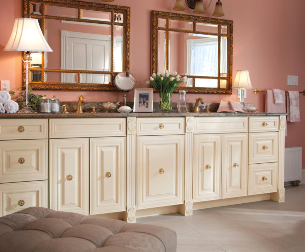 Design ideas for a large traditional master bathroom in Milwaukee with raised-panel cabinets, white cabinets, a freestanding tub, an undermount sink, pink walls, porcelain floors and granite benchtops.
