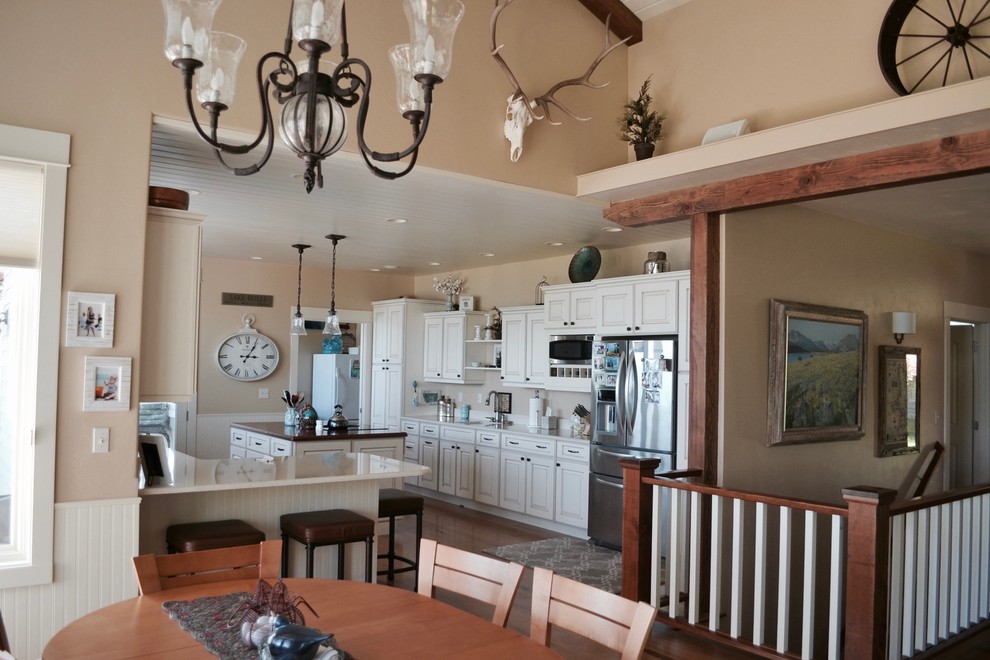 Design ideas for a mid-sized country kitchen/dining combo in Other with beige walls and light hardwood floors.
