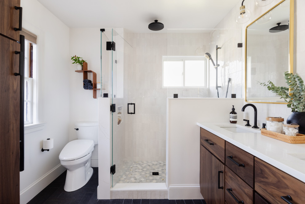 Example of a black floor and double-sink doorless shower design in Boston with dark wood cabinets, white walls, an undermount sink, quartz countertops, a hinged shower door, white countertops and a built-in vanity